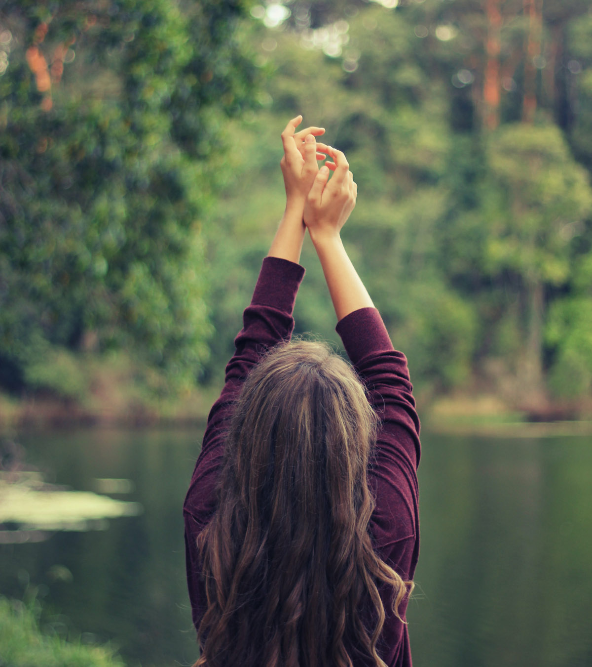 photo of a woman with her hands up practicing mindfulness