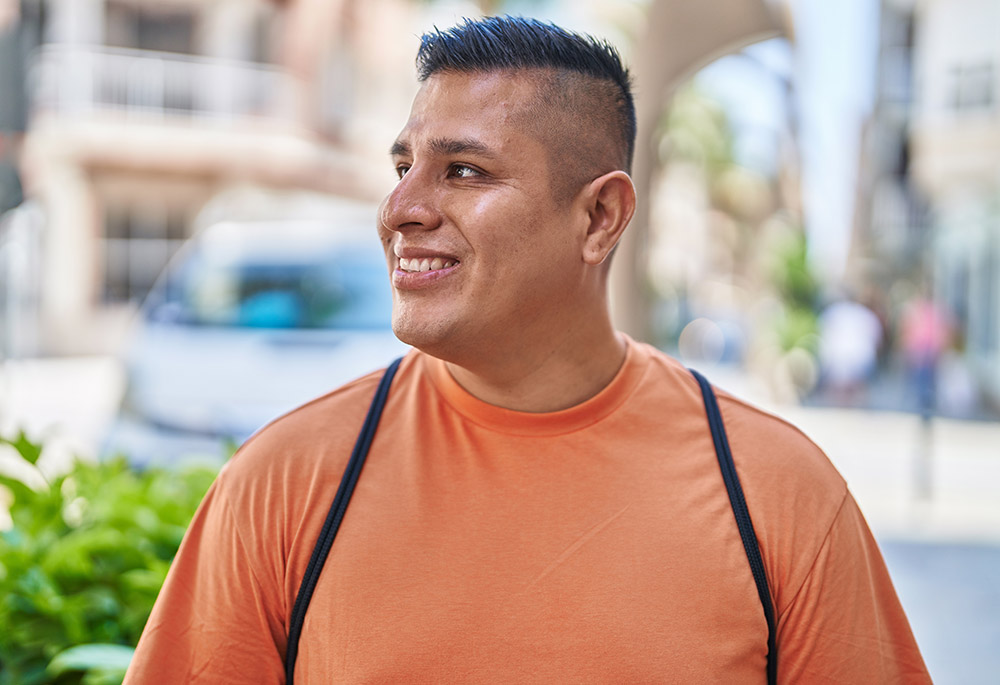 Young latin man smiling confident looking to the side at street Counseling